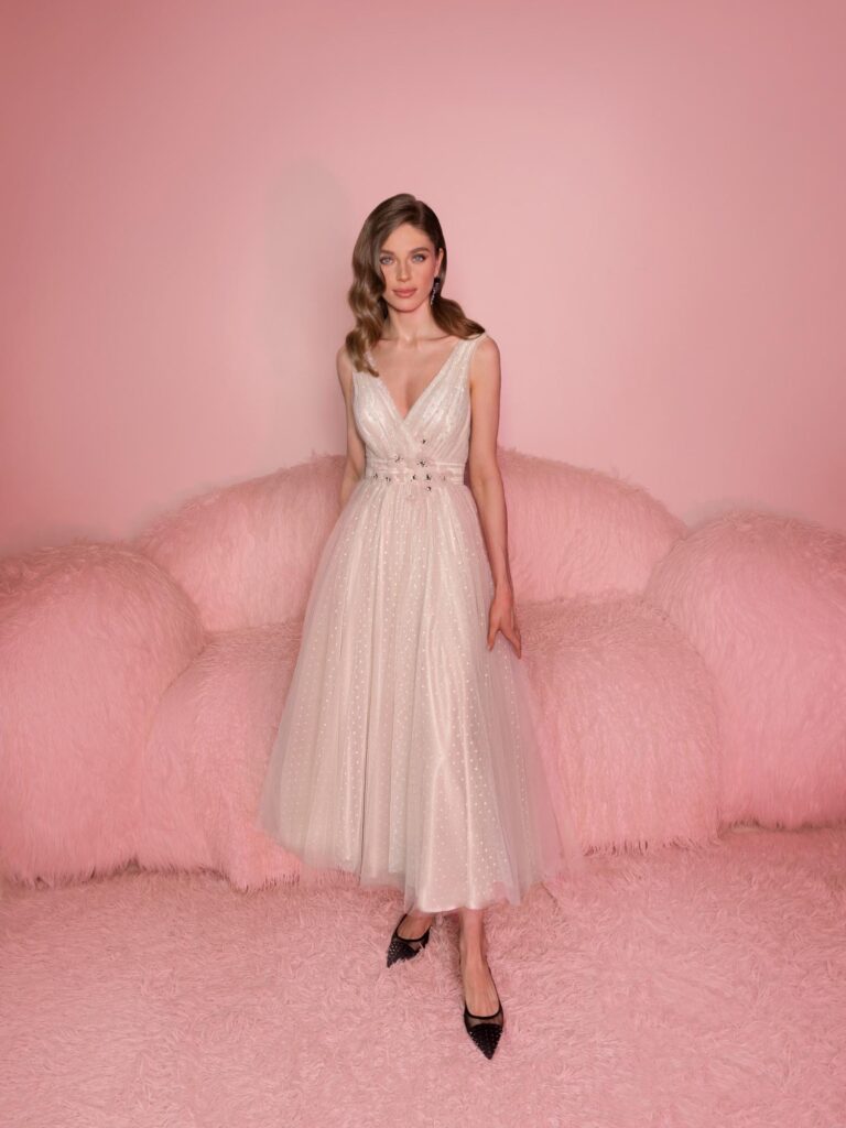 Style #804, polka dot tulle A-line dress with flower decor; available in midi or floor length; in powder (shown online) or cream