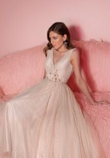 Style #804, polka dot tulle A-line dress with flower decor; available in midi or floor length; in powder (shown online) or cream