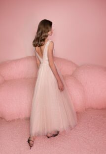 Style #804, polka dot tulle A-line dress with flower decor; available in midi or floor length; in powder (shown online) or cream