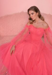 Style #811, off-the-shoulder evening gown with long sleeves; available in midi or floor length; in watermelon (shown online), light green, azure, ivory, black-powder, cherry, blue, purple, powder, pink