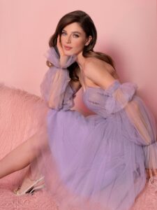 Style #818, strapless tulle A-line dress with detachable long sleeves and beading; available in mini, midi or floor length; in purple (shown online), watermelon, light green, ivory, pink, black, cherry, grey-blue, azure, powder