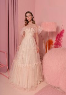 Style #826, shimmering tulle ball gown with ruffled off-the-shoulder neckline and tiered skirt; available in peach (shown online), blue, powder, pink, cornflower blue, green, red, turquoise
