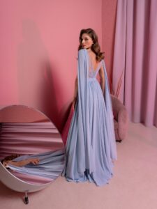 Style #828, chiffon sheath evening gown with cape sleeves and low back; available in grey-blue (shown online), green, purple, light green, watermelon, pink, powder, cherry, azure, black, ivory