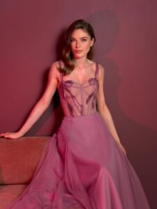 Style #829, tea-length A-line gown with a bustier style bodice and thin straps; available in pink (shown online), light green, ivory, purple, powder, cherry, grey-blue, azure, black, watermelon