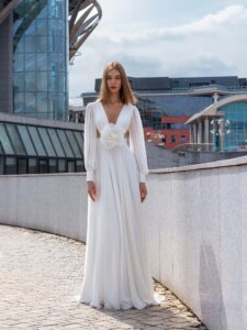 Chiffon wedding dress with cut-outs and floral accent