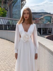 Chiffon wedding dress with cut-outs and floral accent