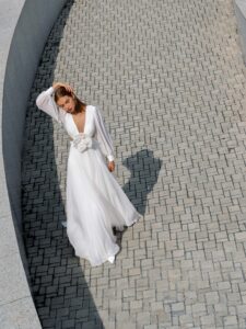 Chiffon wedding dress with cut-outs and floral accent