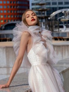 Polka dot A-line wedding gown with flounces; available in powder-cream, ivory