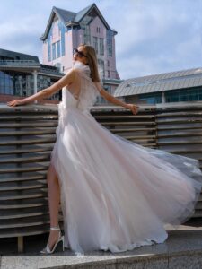 Polka dot A-line wedding gown with flounces; available in powder-cream, ivory