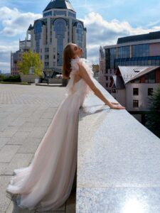 Polka dot A-line wedding gown with flounces; available in powder-cream, ivory