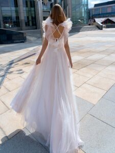 Polka dot A-line wedding gown with flounces; available in powder-cream, ivory