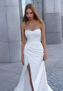 Style #16022, satin wrap-style wedding gown with detachable cape; available in ivory