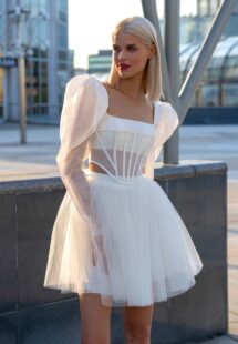 Style #16030a, long sleeve structured corset with a whimsical short skirt; available in ivory