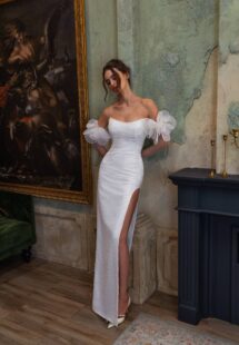 Style #2509, sheath wedding dress with a thigh-high slit and long sleeves; available in ivory