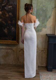 Style #2509, sheath wedding dress with a thigh-high slit and long sleeves; available in ivory