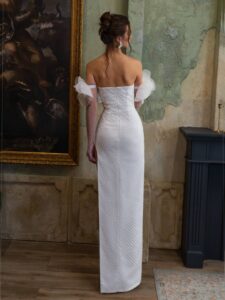 Sheath wedding dress with a thigh-high slit and long sleeves