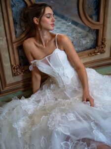 Floral A-line wedding dress with spaghetti straps; available in ivory or pink