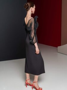 Fitted cocktail dress with sheer sleeves