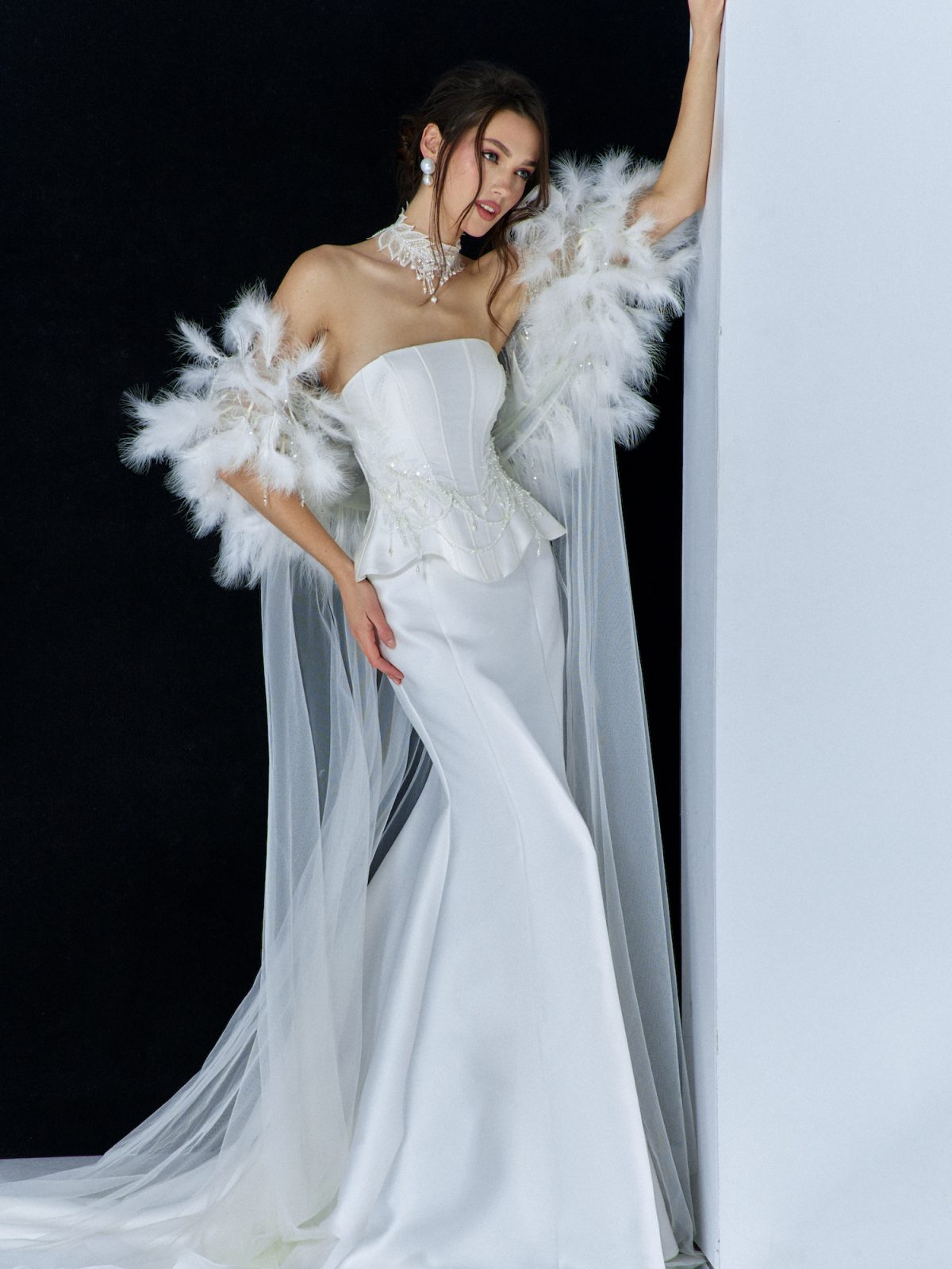 Taylor Swift wedding dress inspiration – elegant strapless satin gown with corset bodice, detachable feathered cape, and pearl accessories from Papilio Boutique Toronto.