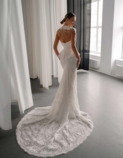 back view of basque waist fit and flare lace wedding dress with pearl-draped collar, available at bridal stores in Toronto
