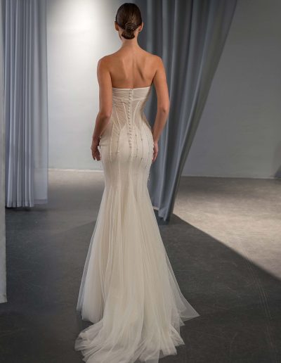 back view of fit and flare wedding dress with cape sleeves and shimmer tulle train, available at bridal stores in Toronto