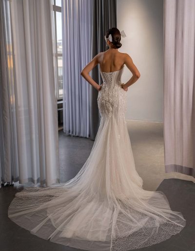 fit and flare wedding dress with basque waist, semi-sheer bodice, boning, and extended tulle train by Papilio Boutique bridal store in Toronto