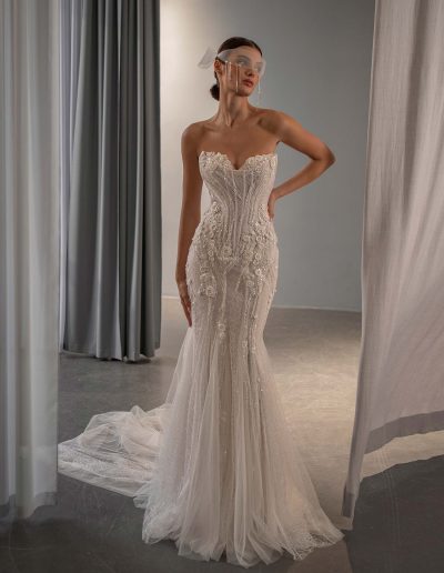 front view of fit and flare wedding dress with basque waist, scoop neckline with peekaboo cups, and mixed tulle and patterned lace by Papilio Boutique bridal store in Toronto