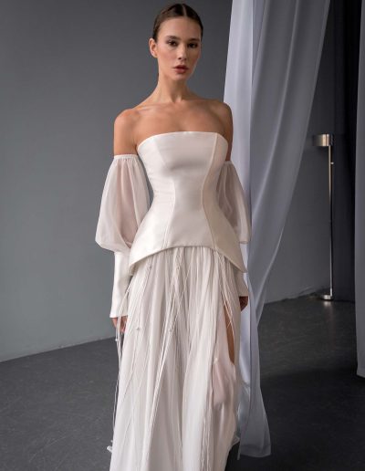 close-up of two piece wedding dress with corset top and beaded skirt by Papilio Boutique in Toronto, featuring mikado bodice and flowing chiffon skirt