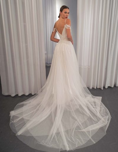 back view of off the shoulder lace and tulle wedding dress with flowing train by Papilio Boutique bridal store in Toronto