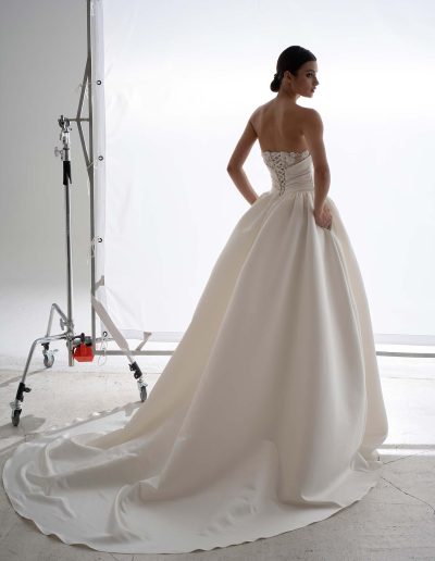 Structured satin ballgown wedding dress with cape by Papilio, voluminous satin skirt and lace-up back — Podium II collection at Papilio Boutique Toronto.