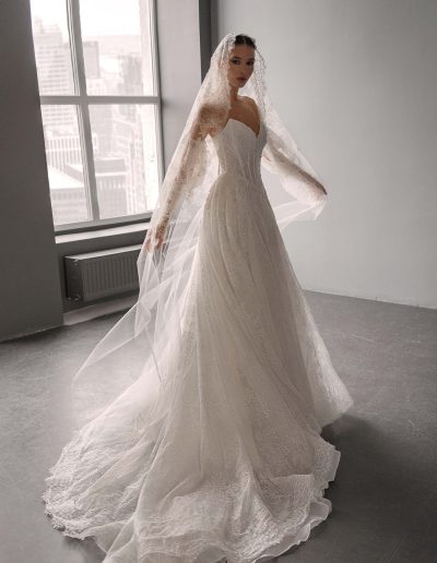 Shimmering lace ballgown wedding dress with detachable sleeves by Papilio, corset bodice with beads and glitter lace skirt — Toronto bridal shop.