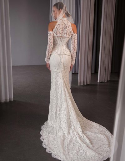 Back view of a lace two-piece wedding dress with a semi-sheer lace corset, lacing back, and matching lace skirt, photographed at Papilio Boutique bridal store in Toronto