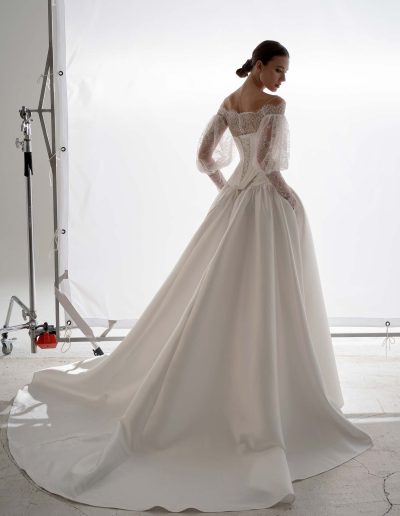 Back view of Mikado two piece wedding dress by Papilio Boutique Toronto with lace-up corset and full dropped-waist skirt, worn with lace bolero.