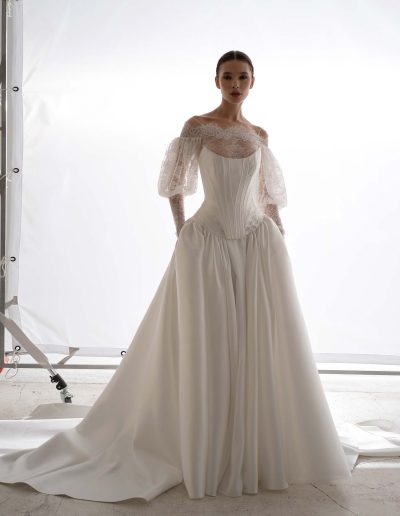 Papilio two piece wedding dress in Toronto featuring corset, dropped-waist skirt, and long-sleeve lace bolero.