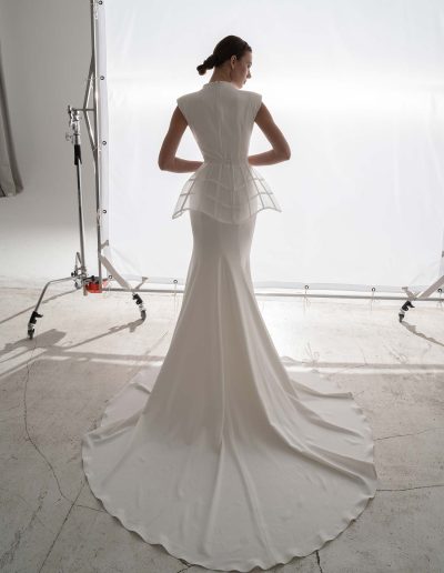 High-neck fit and flare wedding dress with detachable peplum by Papilio Boutique bridal store in Toronto, back view highlighting the sleek train.