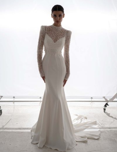 High-neck beaded long sleeve blouse paired with draped fit and flare wedding dress by Papilio Boutique, bridal shop Toronto.