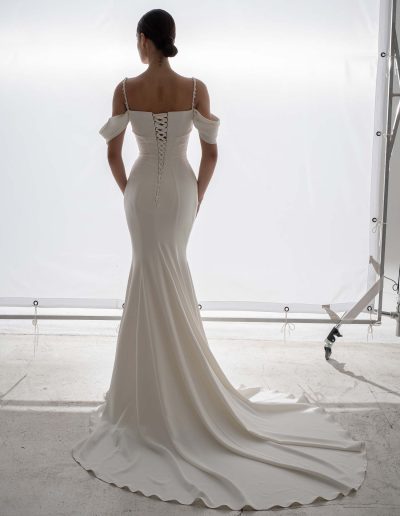 Crepe fit and flare simple wedding dress with beaded spaghetti straps and lace-up back by Papilio Boutique, Toronto bridal store.