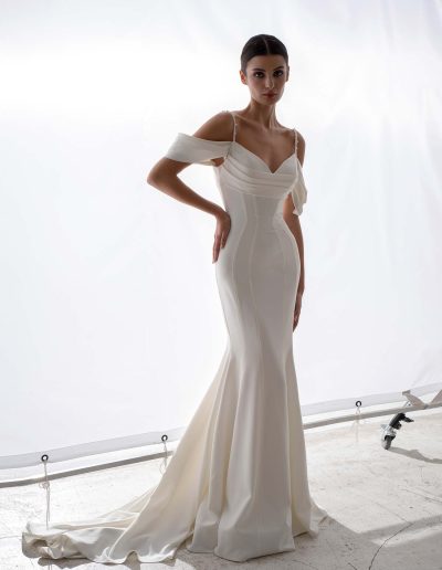 Minimalist simple wedding dress with detachable off the shoulder straps and flared skirt by Papilio Boutique, bridal shop Toronto.