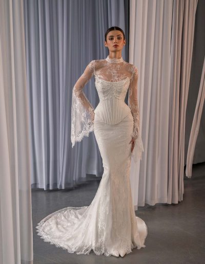 Lace fit and flare wedding dress with bell sleeves by Papilio Boutique, shown at a Toronto bridal store.