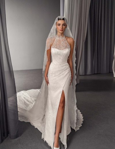 Front view of halter neck wedding dress with lace detailing and open back, by Papilio Boutique bridal store in Toronto.