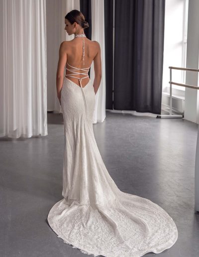 Back view of lace halter neck wedding dress with open back and crisscross straps, by Papilio Boutique bridal store in Toronto.