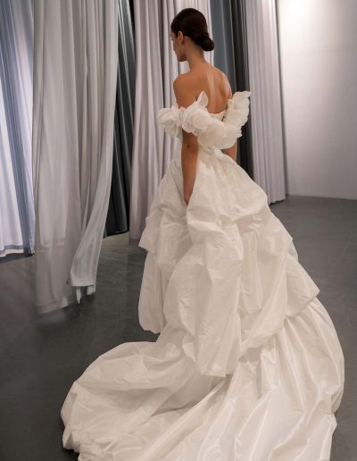 High low wedding dress with dramatic taffeta bubble skirt and sculpted draped corset, offered at Papilio Boutique, Toronto bridal store.