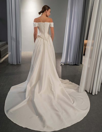 Bridal train detail on simple off the shoulder basque waist wedding dress by Papilio Boutique in Toronto.