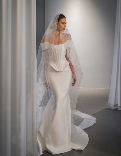 Simple off the shoulder wedding dress with basque waist by Papilio Boutique Toronto bridal shop.