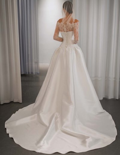 Back view of drop waist ballgown wedding dress with lacing back and lace bolero, dress by Papilio Boutique bridal store in Toronto.