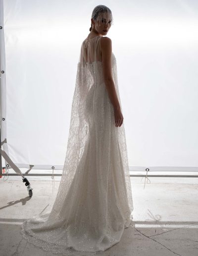 Sheer beaded overlay dress worn over a cut out fit and flare wedding dress by Papilio Boutique, Toronto bridal store.