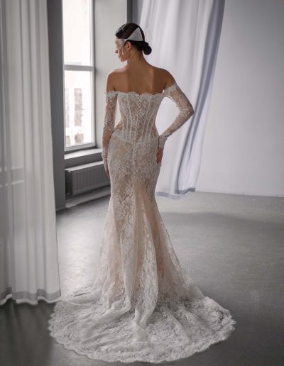 Back view of drop waist fit and flare wedding dress with off the shoulder lace sleeves and scalloped train, by Papilio Boutique, bridal store in Toronto.