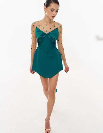 Basque waist cocktail dress with mesh sleeves and embroidered illusion neckline offered at Papilio Boutique dress boutique in Toronto