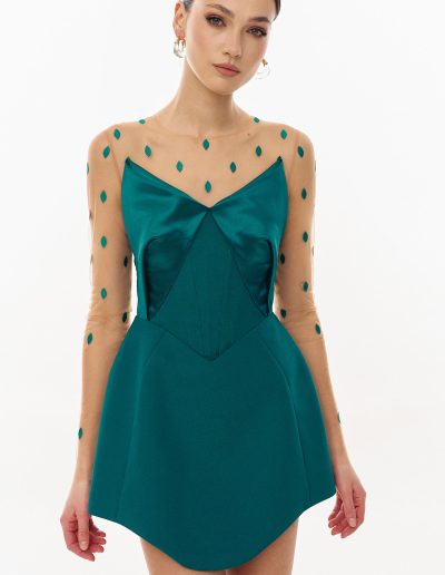 Close-up of basque waist cocktail dress with mesh sleeves and embroidered detail offered at Papilio Boutique Toronto