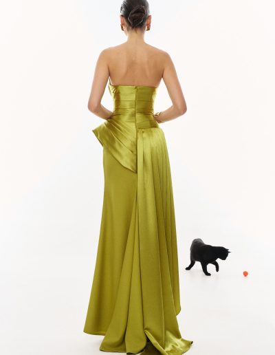 Back view of strapless draped evening gown with fitted bodice and elegant train, offered at Papilio Boutique.